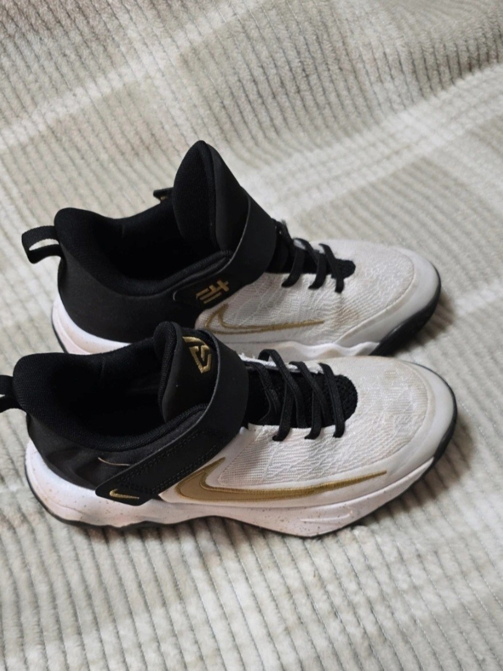 Nike Kids White and Black Sneakers with Gold Swoosh